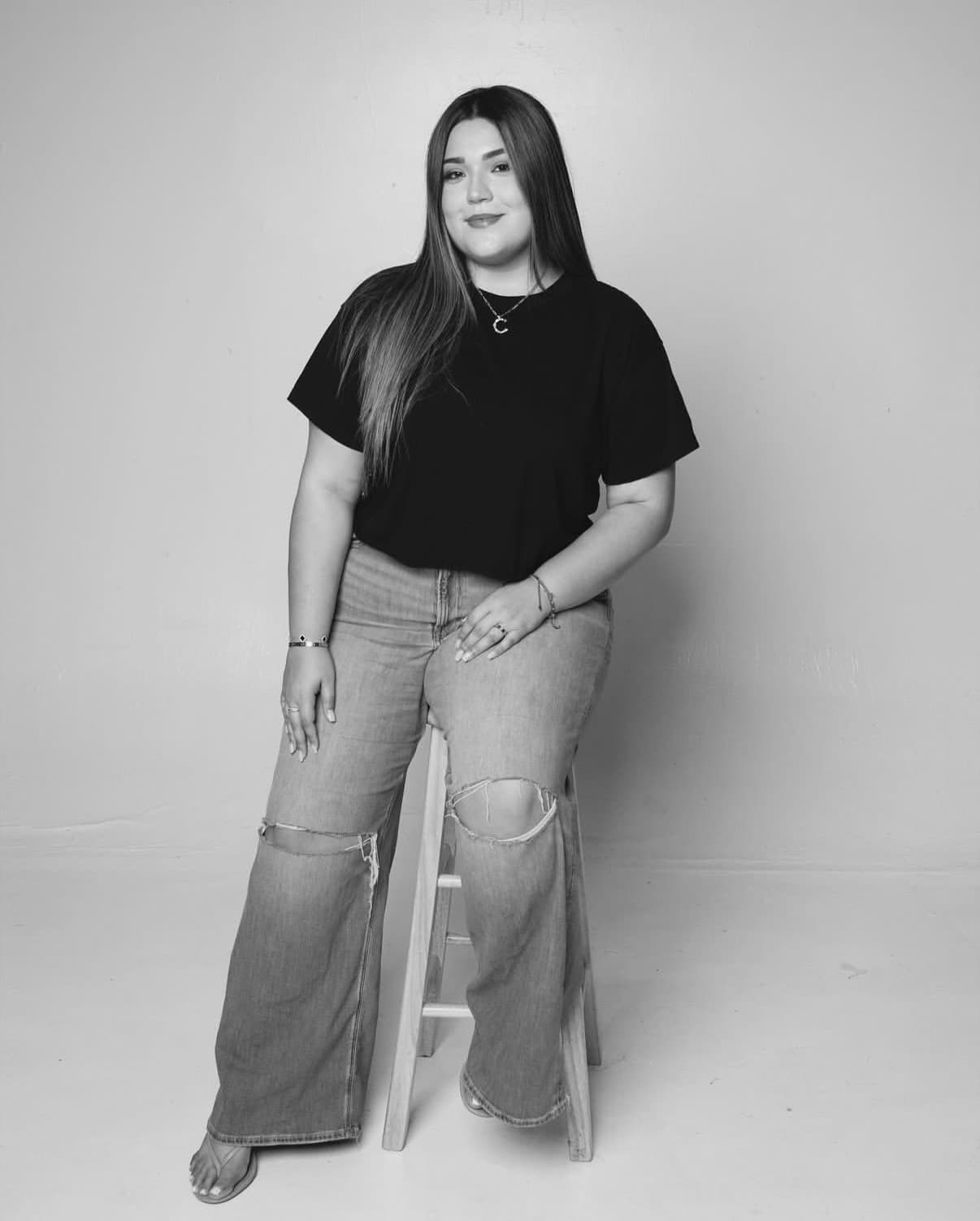 Cait of Cait On Film, independent photography partner of Soratti, in a full-length studio portrait against a plain backdrop.