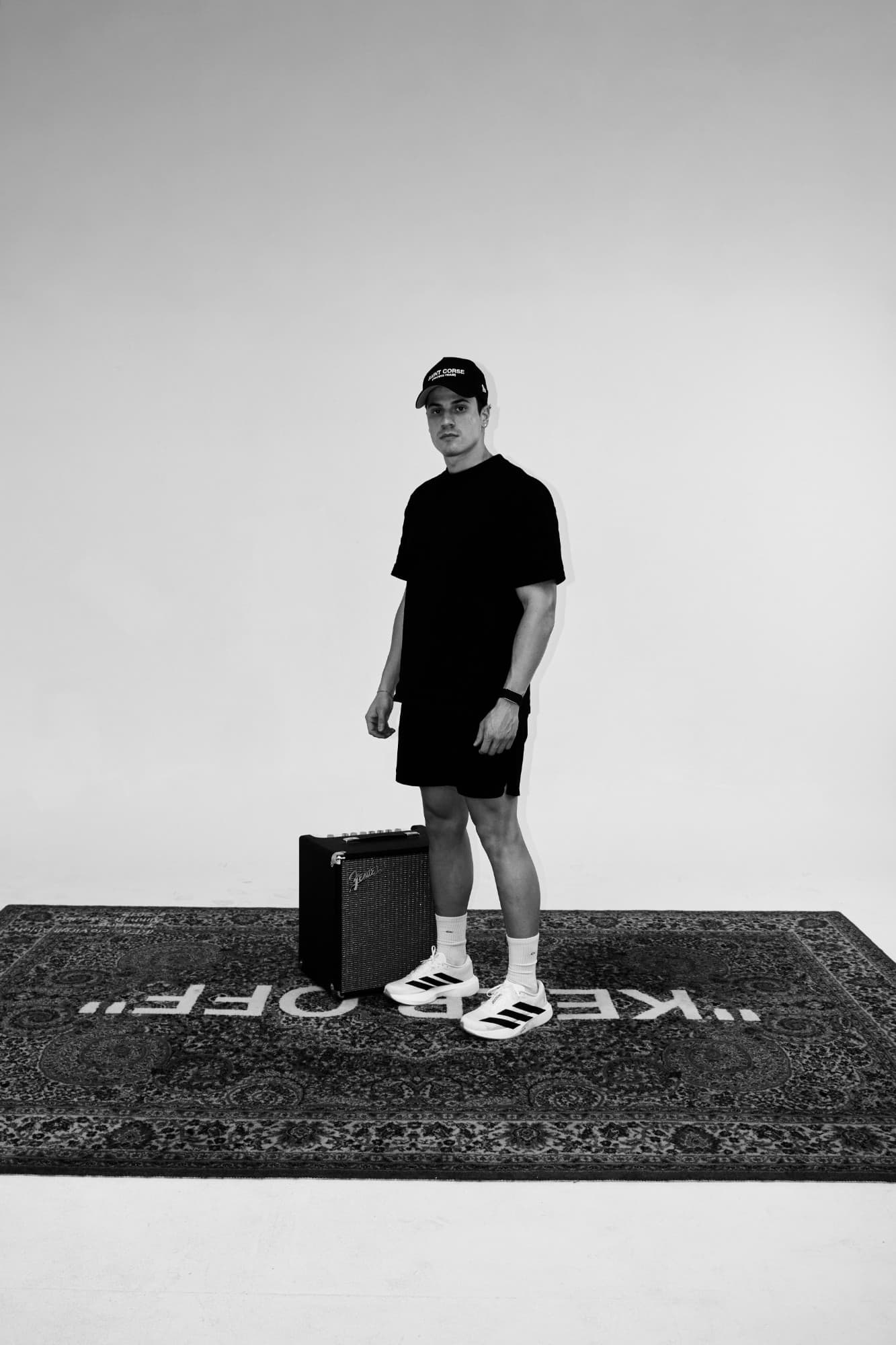 Carlos Nunez, Marketing Lead at Soratti, in a black and white full-length studio portrait.